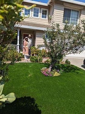 Yard of the Month winners in front of their home